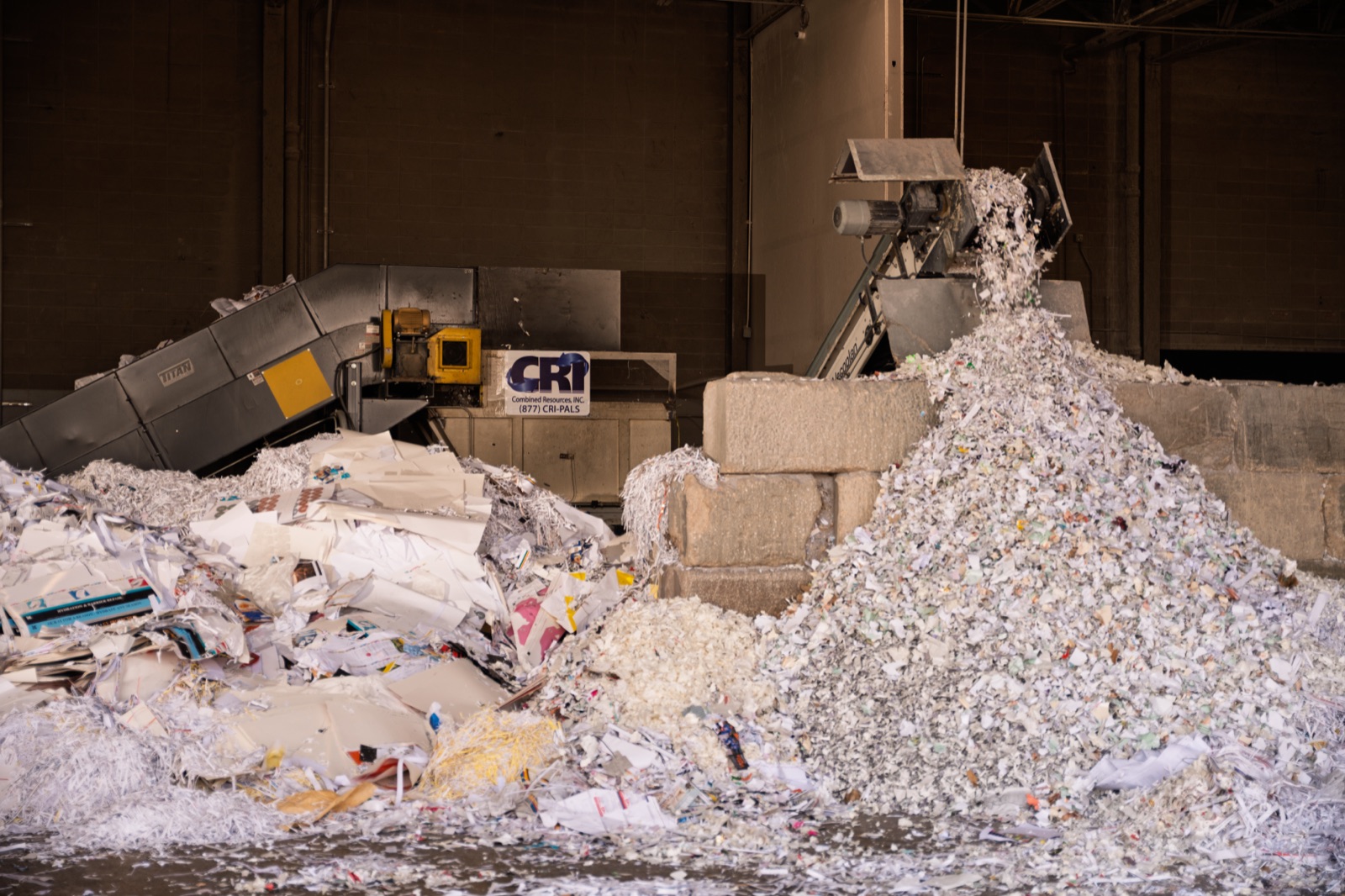 CRI industrial shredder discharging shredded paper from a secure Chicago destruction load